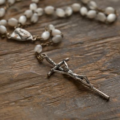 catholic-rosary-at-an-old-wooden-table-VQ8DB28